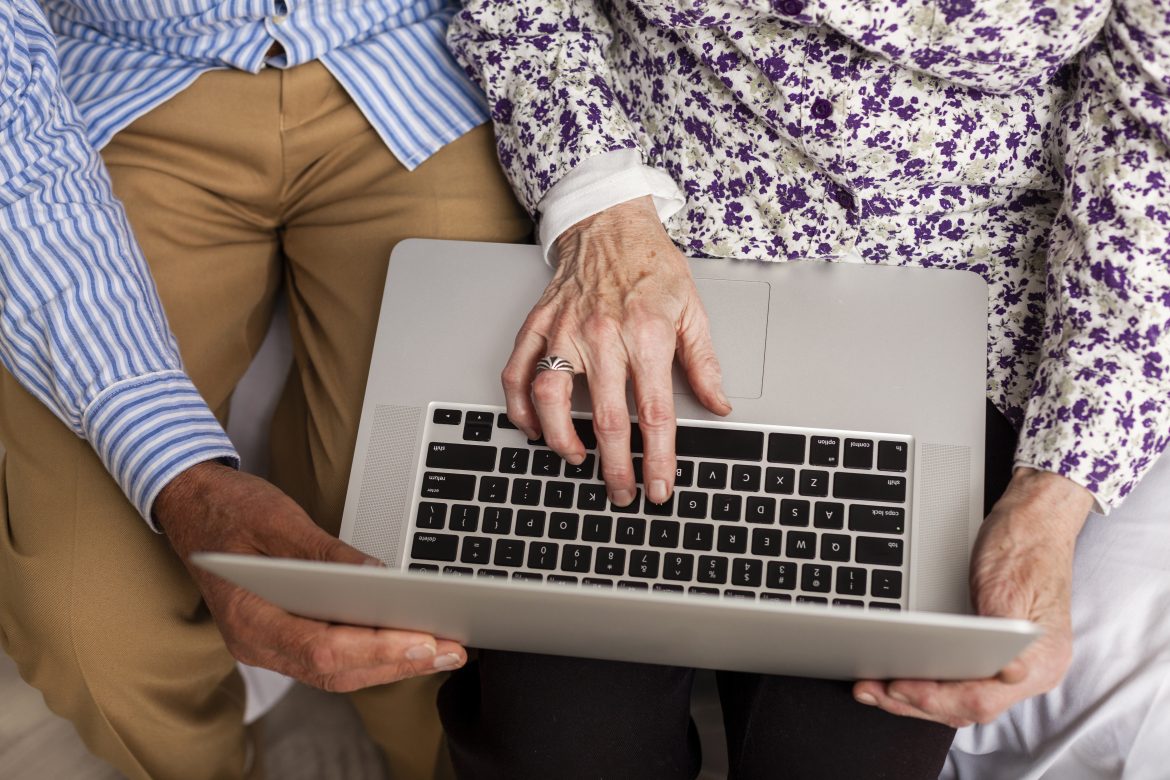 top view senior couple using laptop