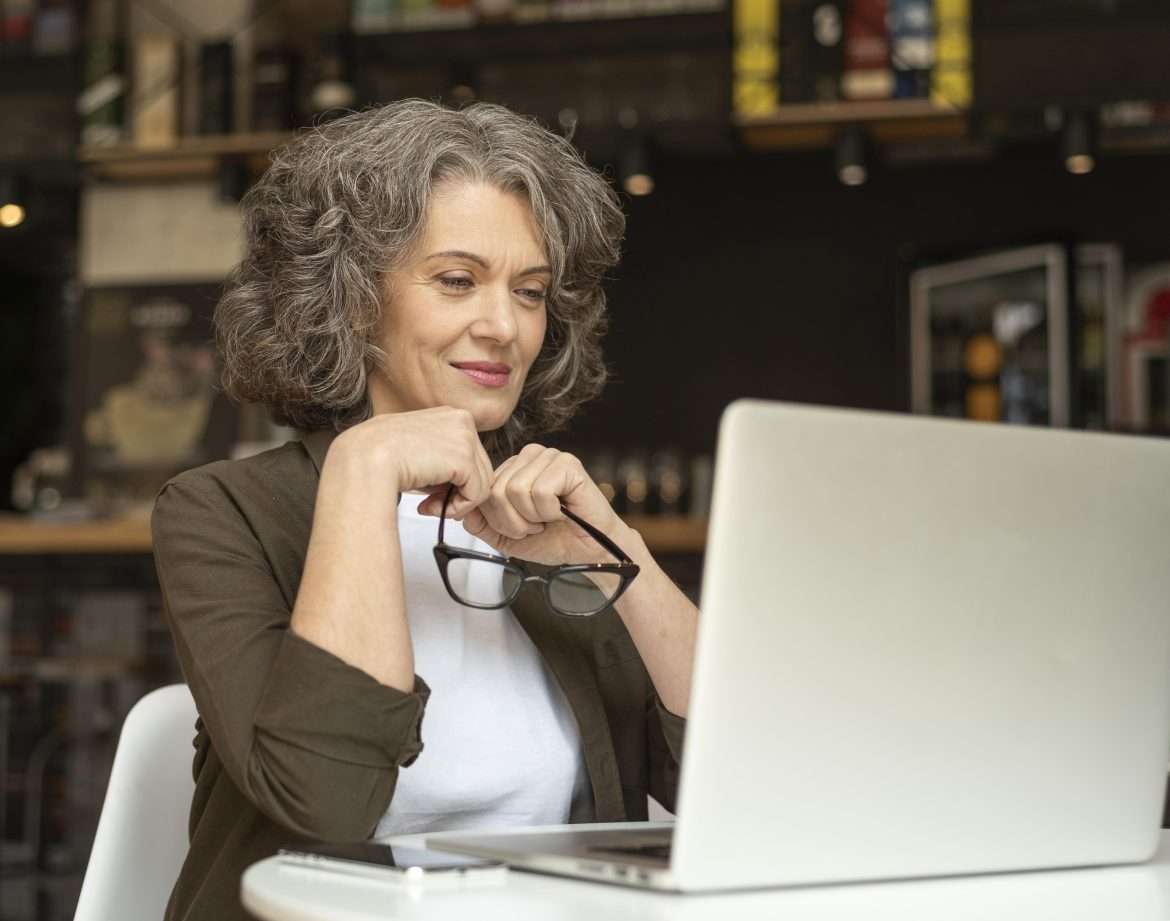 portrait woman with laptop working